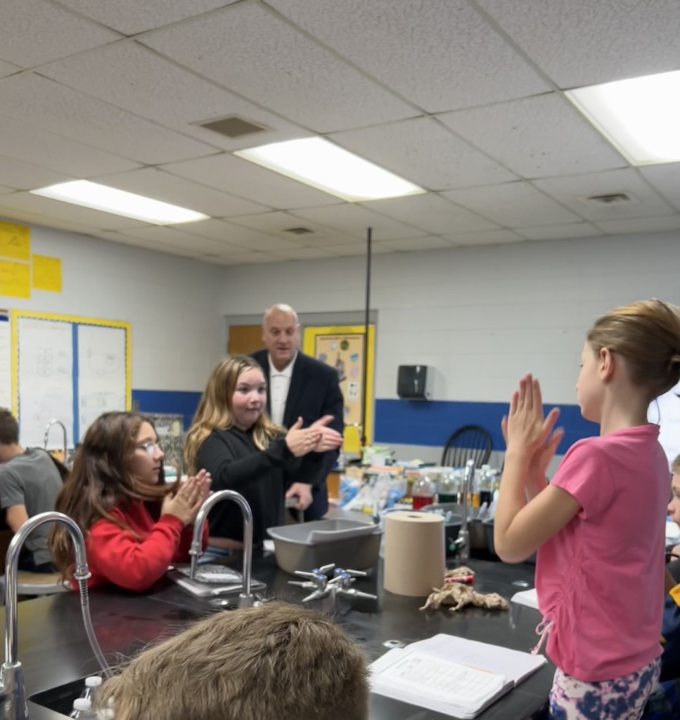 Students clapping in a science class